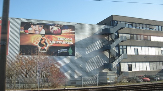 billboard on side of building-train ride from Zurich to Uster